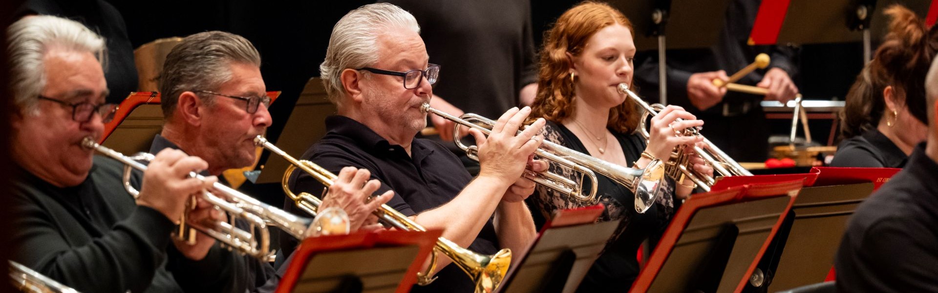 Musicians playing trumpet at a jazz band concert.